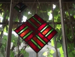 „CROSS OF LAIMA” (Cross of Fortune & Good Luck, with multiple branches) – stained glass by Gints Ūdris, color variations from yellow to red, 7 ½’’x 7 ½’’